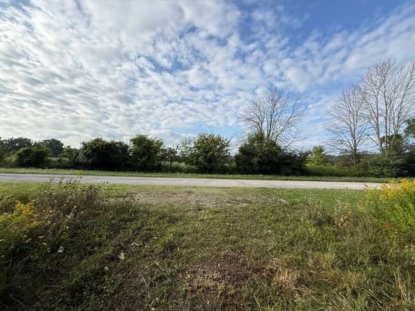View from the property toward the quiet cul-de-sac road with open country beyond.